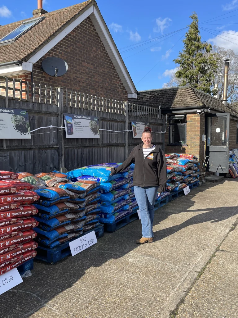 CMH Horticultural - Woman next to Products